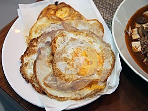 Pile of Fried Eggs beside Szechuan Mapo Tofu