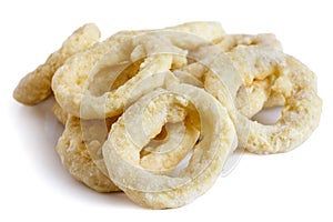 Pile of frozen uncooked battered onion or calamari rings isolate