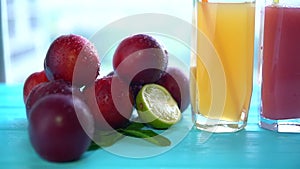 Pile of fruit with glasses of juice or smoothies