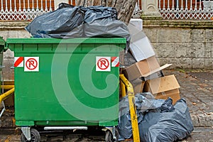 Pile of garbage next to container