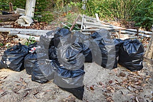 Pile of garbage plastic bag in the nature garbage bag waiting for recycle collection - Waste management concept pollution