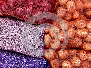 Pile of garlic and onion in net mesh bag for wholesale market