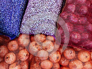 Pile of garlic and onion in net mesh bag for wholesale market