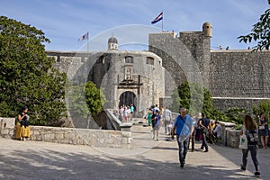 Tourists walk in front of the main entrance of the Old Town gate. Dubrovnik, Croatia