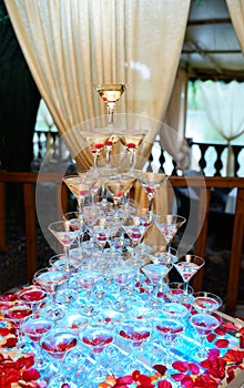 Pile of glasses with cocktails.