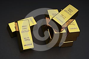 A pile of gold bar a black background.
