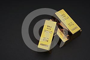 a pile of gold bar on a black background.