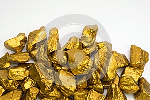 A pile of gold nuggets or gold ore isolated on white background, precious stone or lump of golden stone, financial and business photo