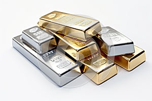 A pile of gold and silver bars of different