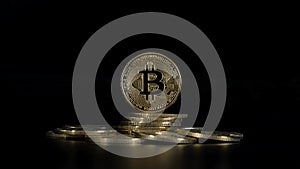 Pile golden Bitcoins on a black background. Close-up bitcoins. Dolly slowly. Crypto currency