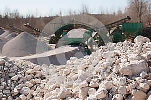 Pile of gravel-rock.Blurred on background machinery of quarry.