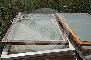 A pile of gray brown old wooden frames of glass and windows