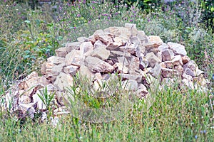 Pile of gray stones in the grass