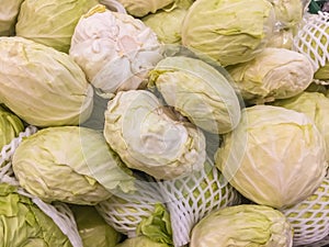 Pile of green fresh cabbages for sale at a supermarket ideal healthy food. Fresh cabbage from farm field, a lot of cabbage at