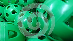 A Pile of Green Perforated Plastic Practice Balls