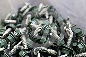Pile of Green roofing screws in a hardware store