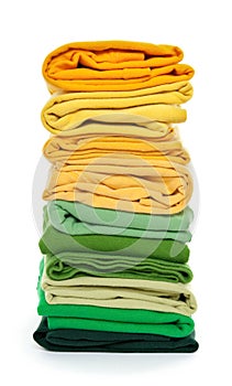 Pile of green and yellow folded clothes