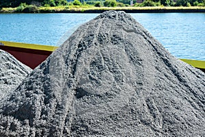 Pile of grey cement in a cargo ship, Oupeye, LiÃ¨ge, Belgium