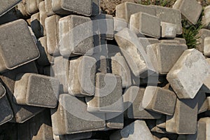 A pile of grey concrete bricks
