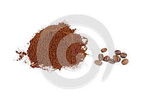 Pile of the ground coffee and few beans isolated on white