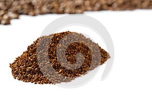 Pile of the ground coffee flakes isolated over the white background. pile of melted coffee