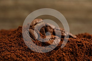 Pile of ground coffee with roasted beans, closeup