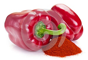 Pile of ground paprika with pepper on white background