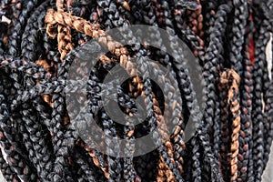 Pile of hair braids for braiding hair in a hair saloon