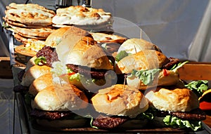 Pile of hamburgers on a tray, ready to be served at the fast food restaurant