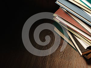 Pile of hardcover books in a shadowy room