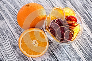 A pile of healthy colorful fruit chips on a white background in a transparent plate. View from above.