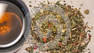 Pile of healthy herbs near a cup of herb tea isolated. Concept healthy diet, supplements, and food