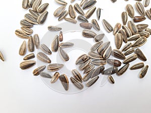 Pile and heap of a black color sunflower seeds with shell texture isolated on white background