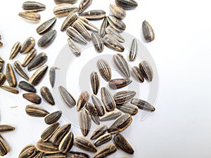 Pile and heap of a black color sunflower seeds with shell texture isolated on white background