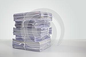 Pile or heap of financial business document paperwork stack on office desk concept of workload overtime or workplace paperless