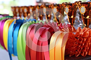 Pile of horse riding ribbons and trophy awards. Group of beautiful colorful trophies