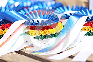 Pile of horse sport trophies rosettes at equestrian event