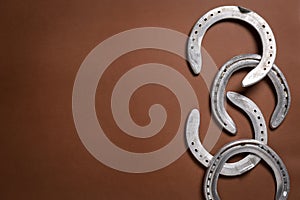 Pile of horseshoes on a brown background