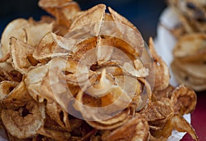 Pile of hot, deep fried potato chips from the midway