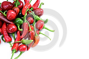 Pile of hot peppers border with space for text. Different green and red hot chili peppers frame isolated on white