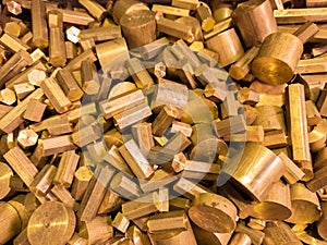 A pile of industrial scrap - brass turning leftovers and cutt off waste - waiting for recycle.