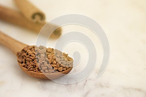 Pile of instant coffee grains over marbble surface. Caffiene drink. Copy space, toned.