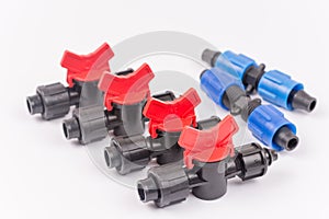 Pile of irrigation tools and valves over white