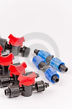 Pile of irrigation tools and valves over white