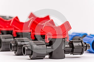 Pile of irrigation tools and valves over white