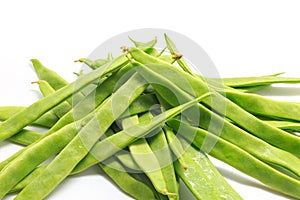Pile of italian flat green beans on a white background photo