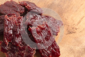 Pile of Kippered Beef Steak Beef Jerky on a Rustic Wooden Table