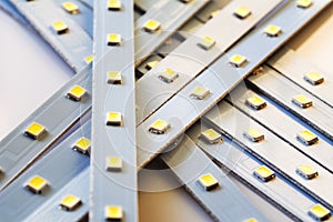 Pile of Led smd screen strip on white background. Diode strip. LED lights tape pattern. Selective focus, shallow depth of field