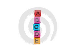 Pile of letter bead or beads with alphabet ABCDE on white background