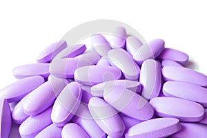 Pile of Lilac purple color oval shaped supplement pills